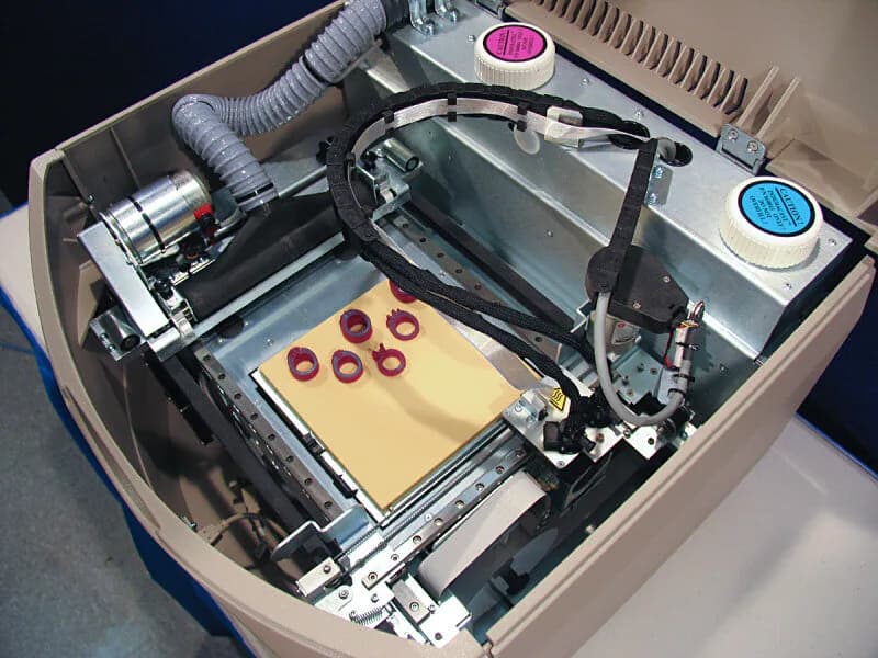 3D-printed wax ring samples on a printer bed.